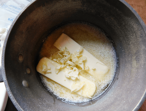 Butter and garlic melting in a medium saucepan