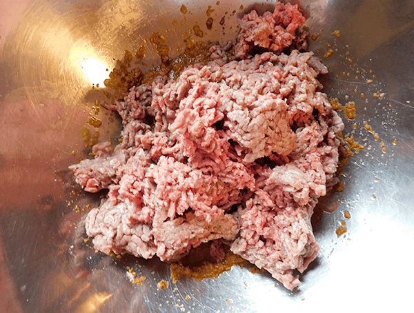 Ground Beef and seasonings in bowl