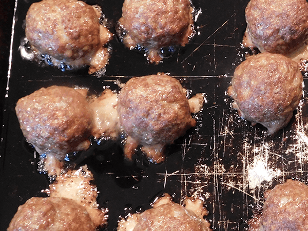 Cooked Mongolian meatballs on baking sheet