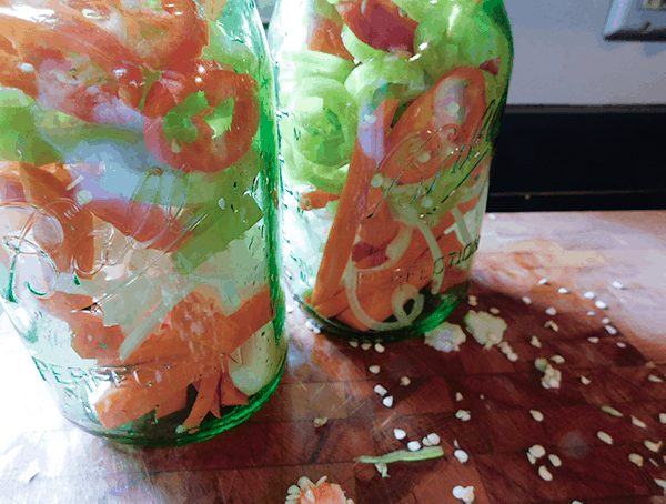 Carrots, peppers onions and garlic in jars ready to be made into Quick Pickles