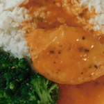 Close up of French Chicken on a white plate with rice