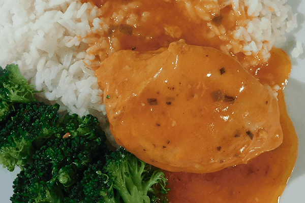 Close up of French Chicken on a white plate with rice