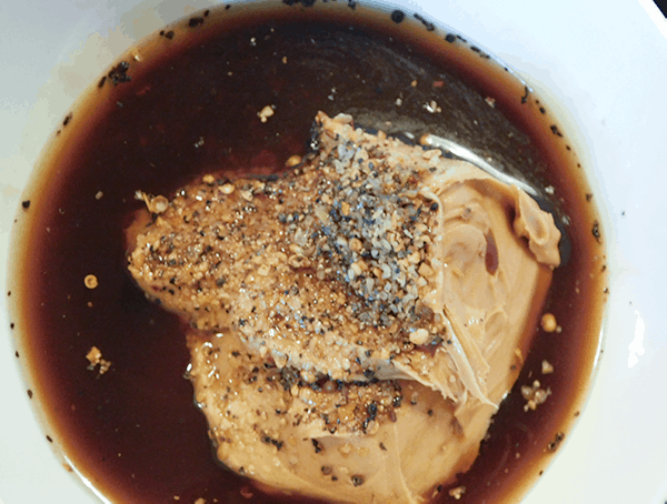 Peanut Butter, seasonings and worcestshire sauce in a white bowl