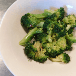 Cooked Spicy Broccoli in a white bowl