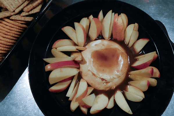 Caramel Apple Cream Cheese Dip on a platter with apples