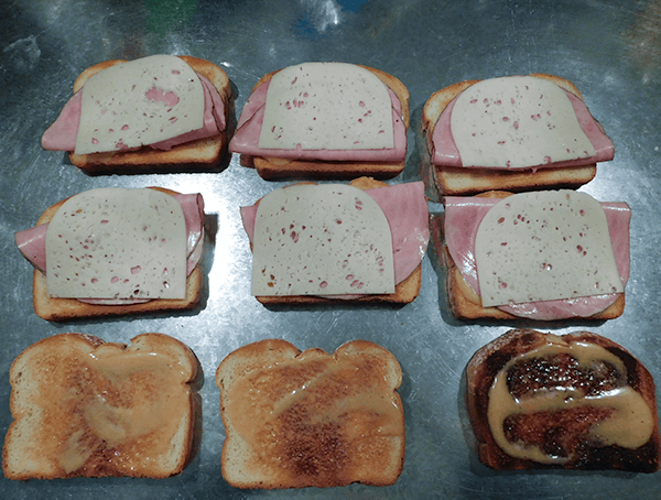 Toast smeared with honey mustard and topped with ham and cheese