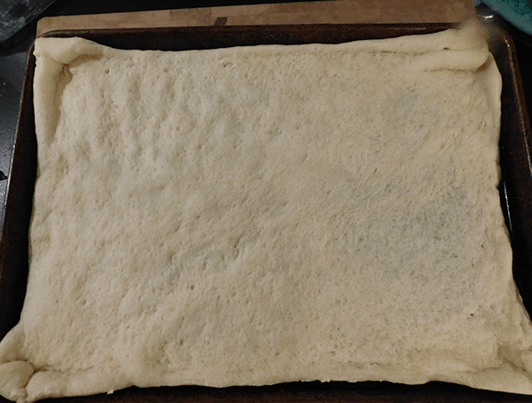 Par-baked pizza shell in a sheet pan