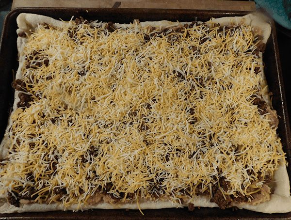 Taco Pizza ready to go back in the oven