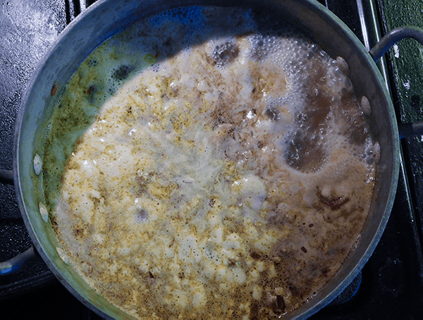 Sausage split pea soup bubbling in a Dutch oven