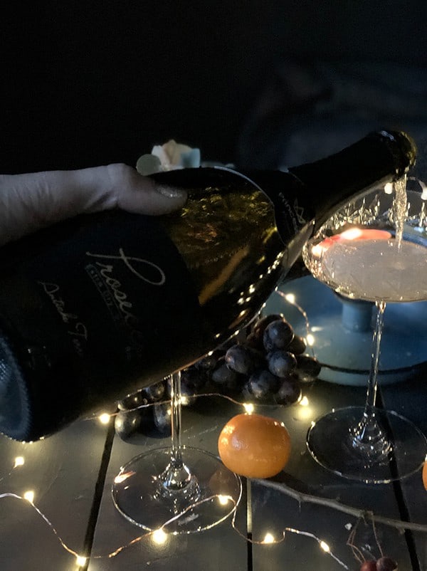 Champagne being poured into a coupe glass 