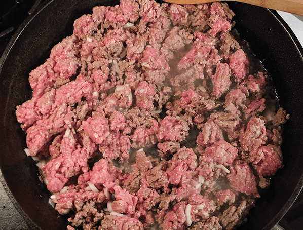 Sloppy Joe Slider meat cooking in a cast iron skillet 