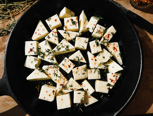 Fontina and mozzarella cheese in a cast iron skillet