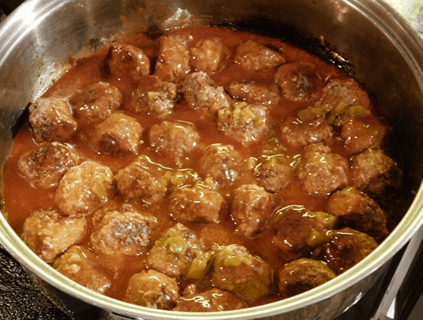 Yummy Mexican Meatballs covered in enchilada sauce