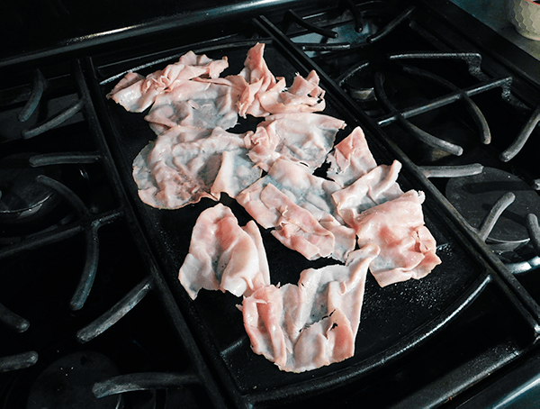 Deli ham warming through on a griddle 