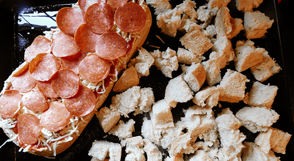 Pizza Dip in a loaf of bread, ready for the oven. 