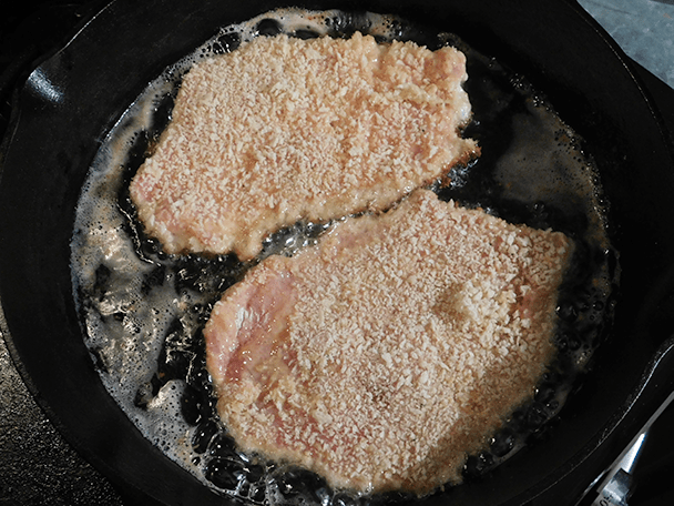 Cutlets in cast iron skillet for Pork Milanese